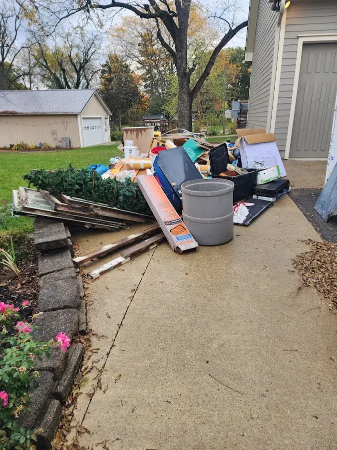 Dumpster being loaded with debris for Roofing Dumpster Rental in Laconia